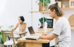 A view of two remote workers in a flexible workspace.